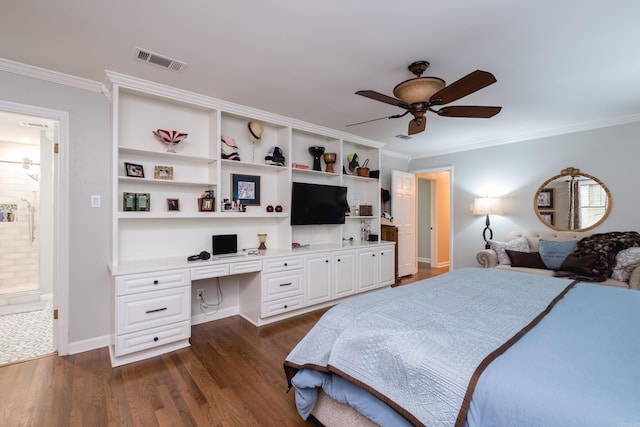 bedroom featuring crown molding, ceiling fan, built in desk, visible vents, and dark wood-style floors