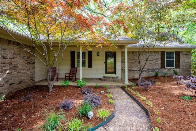 view of front of property with covered porch and brick siding