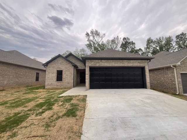 view of front of property with brick siding, a garage, and driveway