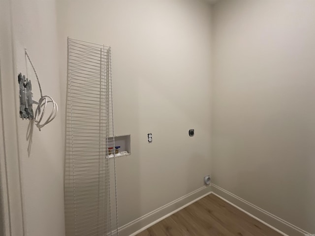 clothes washing area featuring laundry area, dark wood-style flooring, baseboards, washer hookup, and hookup for an electric dryer