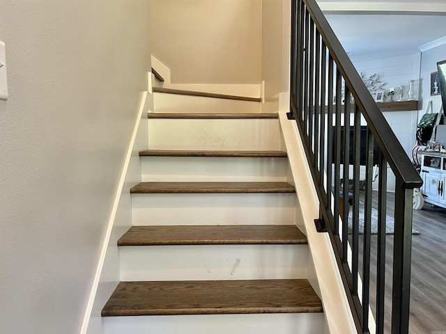 staircase featuring wood finished floors