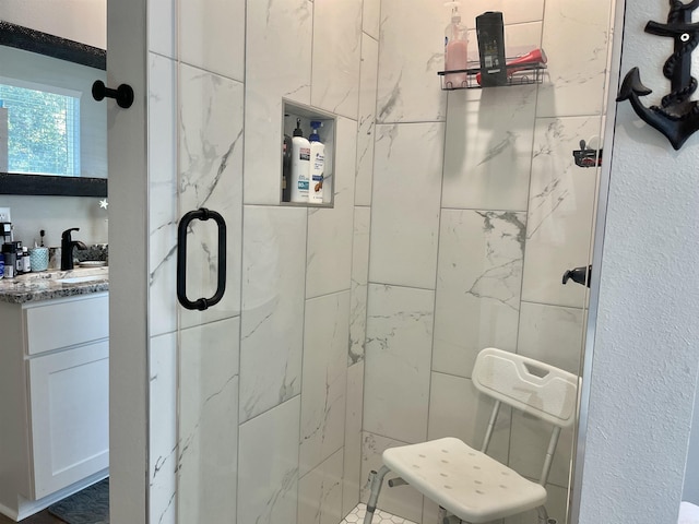 full bathroom with a shower stall and vanity