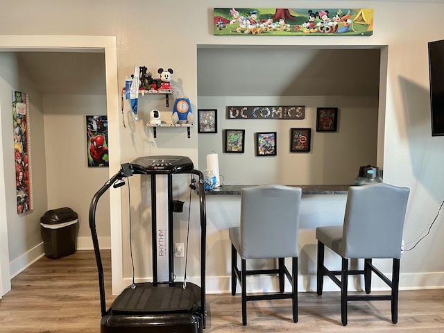 bar with baseboards and wood finished floors
