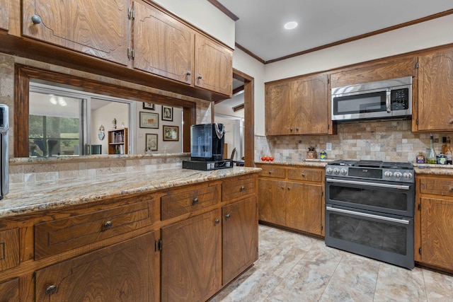 15 Tarifa Ln, Hot Springs Village, AR 71909 - kitchen with crown molding, decorative backsplash, stainless steel microwave, and range with two ovens