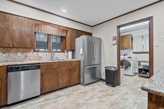 15 Tarifa Ln, Hot Springs Village, AR 71909 - kitchen with crown molding, appliances with stainless steel finishes, a sink, light countertops, and washer / dryer