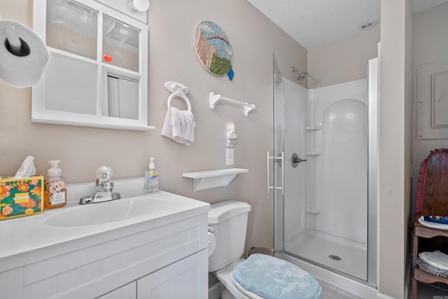 15 Tarifa Ln, Hot Springs Village, AR 71909 - bathroom with a textured ceiling, tile patterned flooring, a shower stall, vanity, and toilet