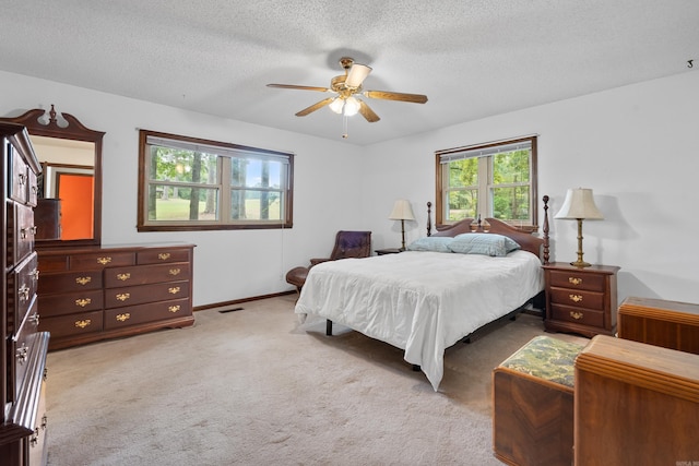 15 Tarifa Ln, Hot Springs Village, AR 71909 - bedroom with ceiling fan, light colored carpet, a textured ceiling, baseboards, and visible vents