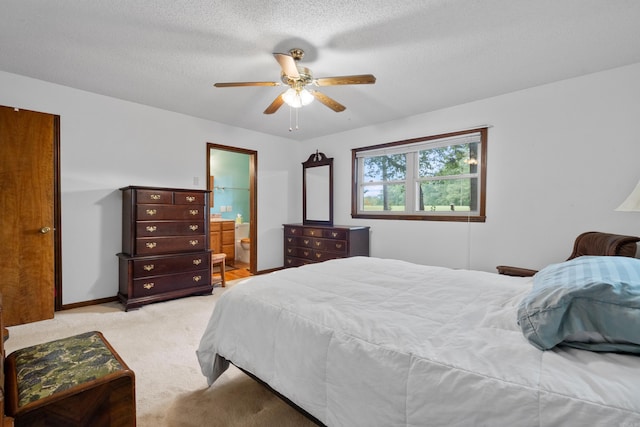 15 Tarifa Ln, Hot Springs Village, AR 71909 - bedroom with baseboards, light colored carpet, connected bathroom, a textured ceiling, and a ceiling fan