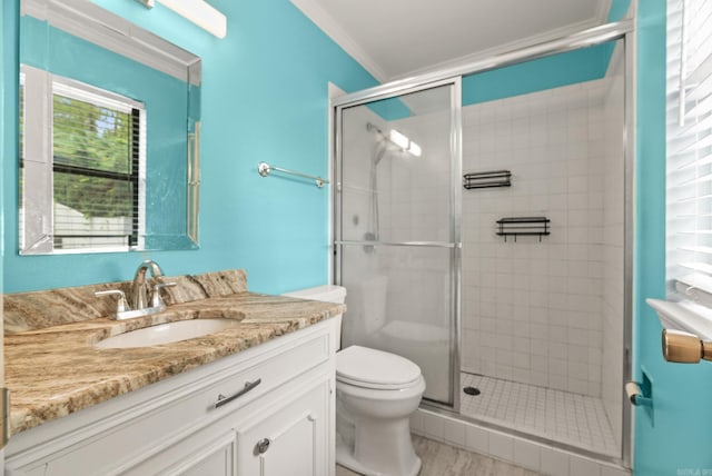 full bath featuring crown molding, vanity, a stall shower, and toilet