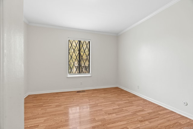 unfurnished room with crown molding, baseboards, and light wood finished floors