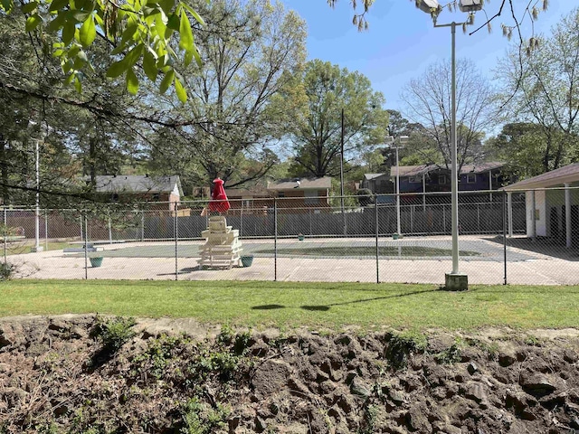 view of tennis court featuring fence
