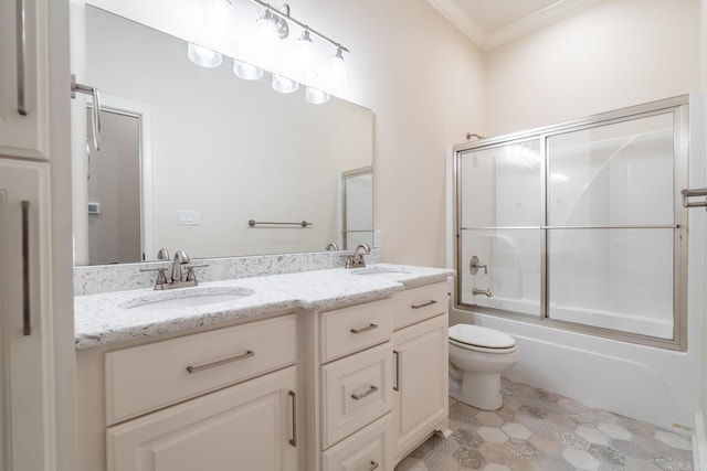 full bathroom featuring crown molding, a sink, double vanity, and toilet