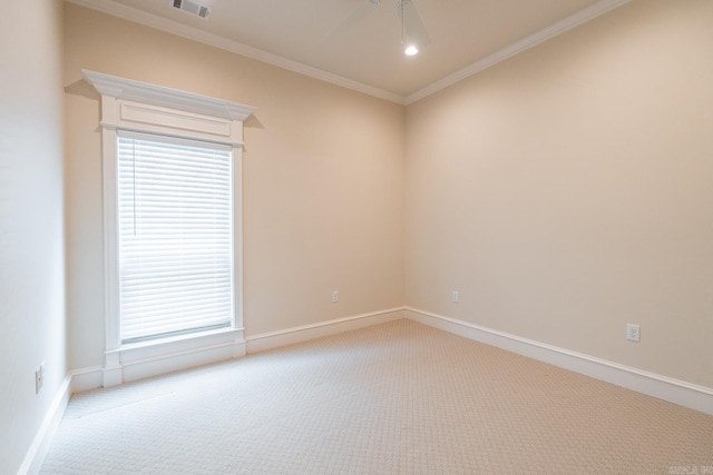 carpeted empty room featuring baseboards, ceiling fan, ornamental molding, and visible vents