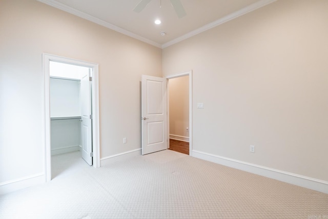unfurnished bedroom with crown molding, a closet, baseboards, light colored carpet, and recessed lighting