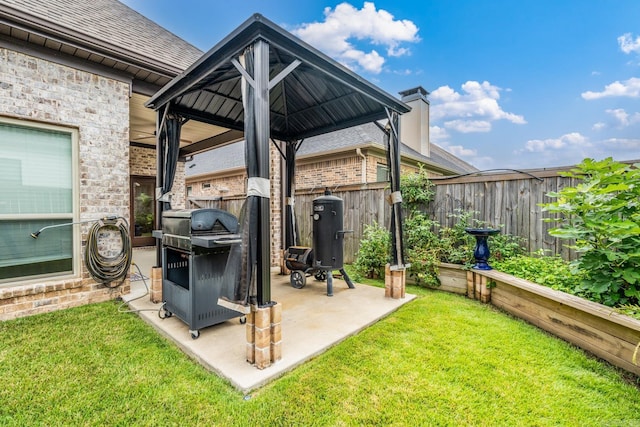 view of patio with fence, a gazebo, and a grill