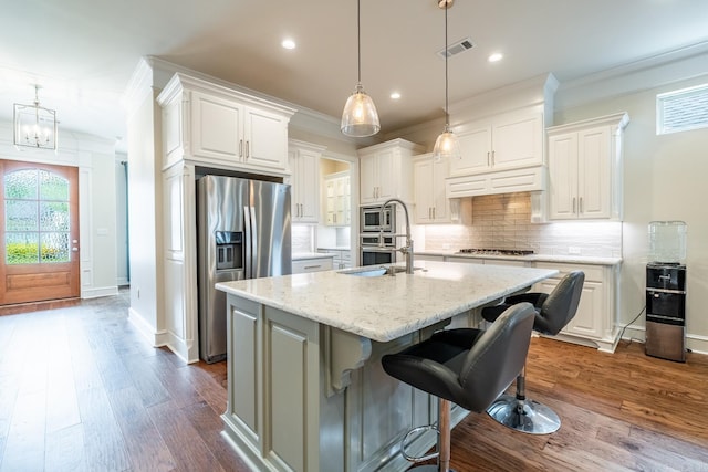 kitchen featuring crown molding, recessed lighting, appliances with stainless steel finishes, and visible vents