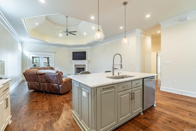 kitchen featuring crown molding, a ceiling fan, a fireplace, a sink, and dishwasher