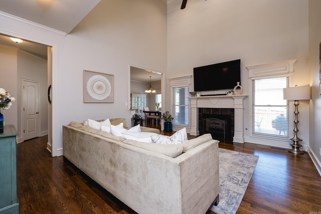 living room featuring crown molding, ceiling fan, high vaulted ceiling, plenty of natural light, and dark wood-type flooring