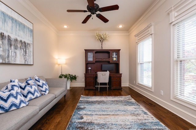 office area featuring a ceiling fan, baseboards, wood finished floors, visible vents, and ornamental molding