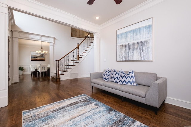 living area featuring visible vents, ornamental molding, wood finished floors, and stairway
