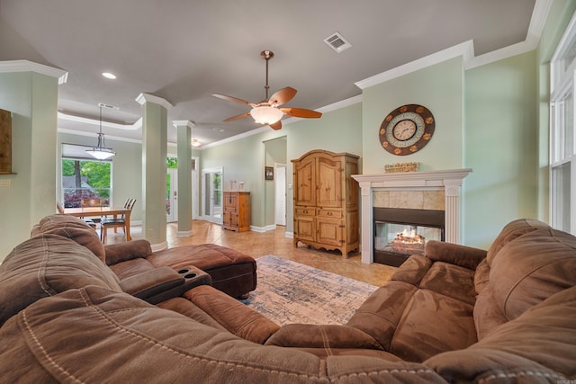 living area with ceiling fan, visible vents, light tile patterned floors, baseboards, and ornamental molding