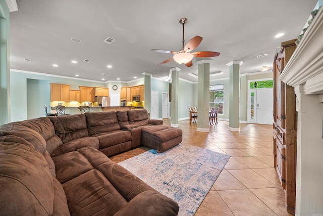 living area featuring recessed lighting, ornate columns, ornamental molding, and light tile patterned floors