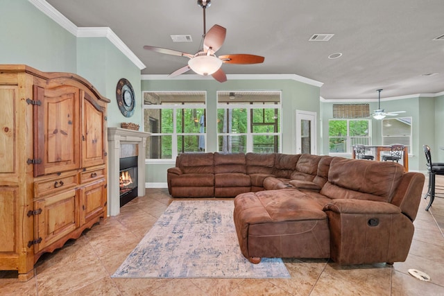 living room with crown molding, ceiling fan, visible vents, and baseboards