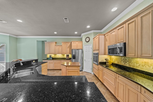 kitchen featuring visible vents, a sink, ornamental molding, and stainless steel appliances