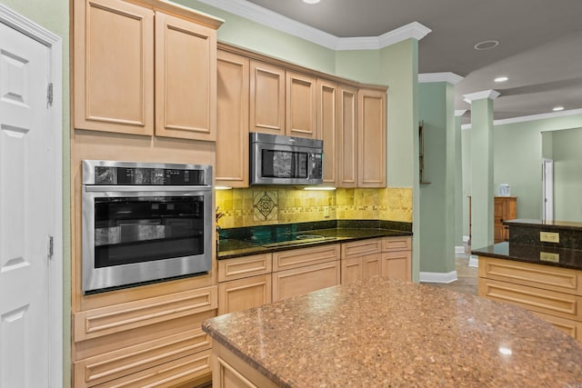 kitchen with crown molding, appliances with stainless steel finishes, tasteful backsplash, dark stone countertops, and ornate columns