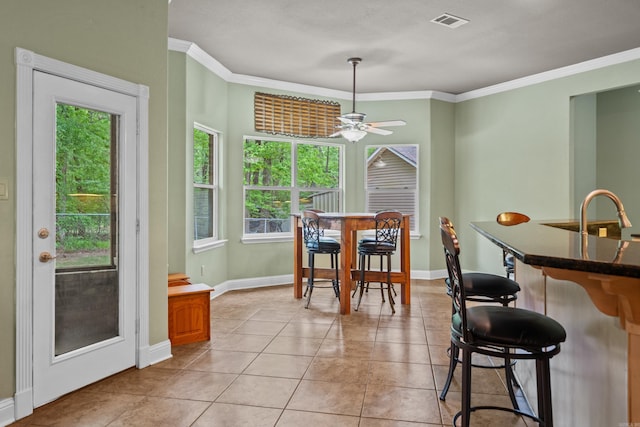 dining area featuring crown molding, ceiling fan, visible vents, and light tile patterned floors