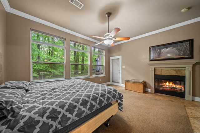 bedroom with visible vents, baseboards, crown molding, and multiple windows