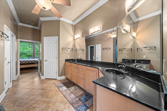 ensuite bathroom featuring a sink, ceiling fan, visible vents, and crown molding