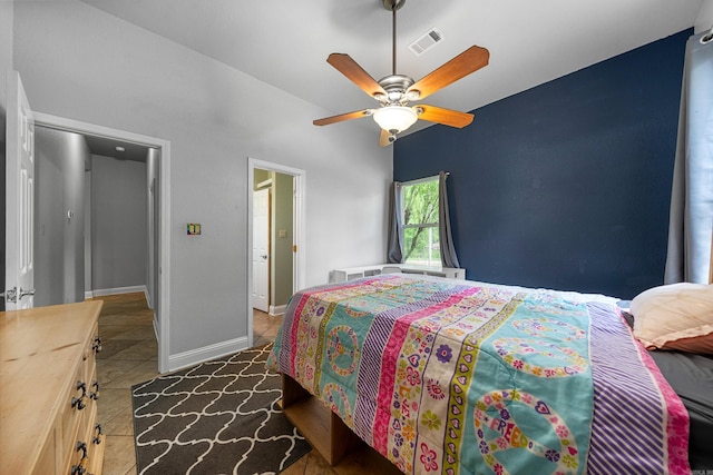 tiled bedroom with a ceiling fan, baseboards, and visible vents