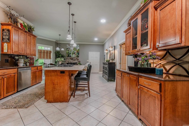 kitchen with a kitchen island, light tile patterned floors, stainless steel dishwasher, ornamental molding, and glass insert cabinets