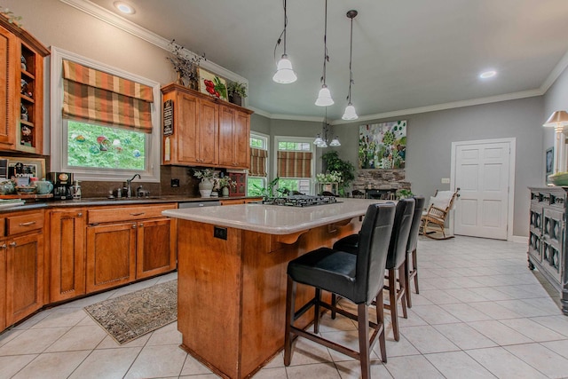 kitchen with a sink, light tile patterned floors, backsplash, and ornamental molding