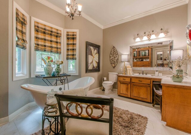 bathroom with a freestanding bath, an inviting chandelier, vanity, marble finish floor, and ornamental molding