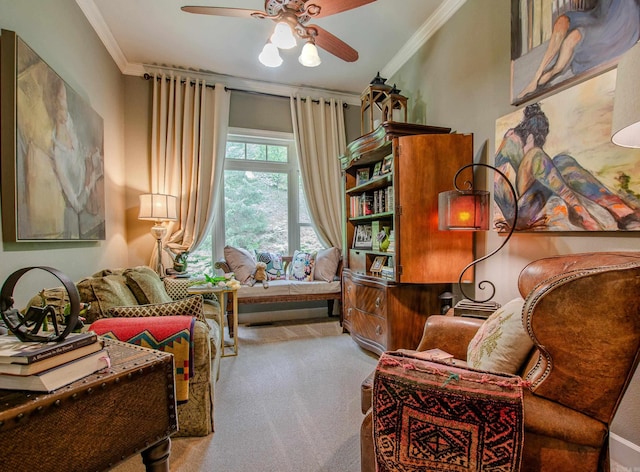 living area with ornamental molding, carpet, and ceiling fan