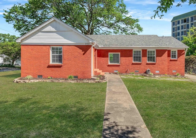 view of front facade with brick siding, crawl space, a front yard, and roof with shingles