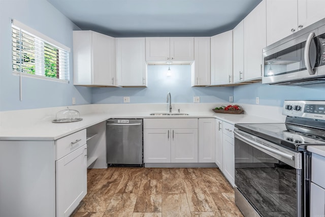 kitchen featuring a sink, appliances with stainless steel finishes, and light countertops