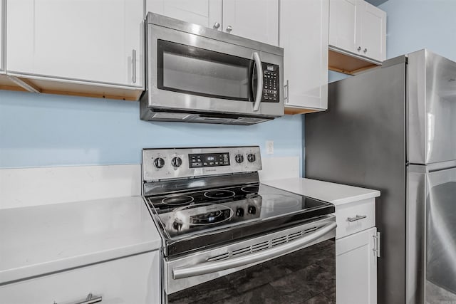 kitchen with light countertops, appliances with stainless steel finishes, and white cabinets