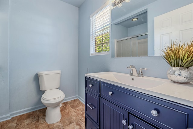 bathroom with vanity, baseboards, toilet, and a shower stall