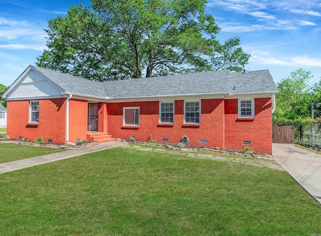 ranch-style home featuring crawl space, a front yard, roof with shingles, brick siding, and fence