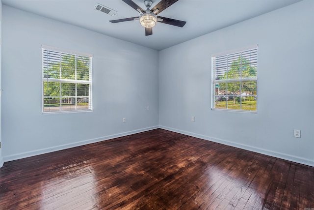 unfurnished room featuring visible vents, baseboards, ceiling fan, and hardwood / wood-style floors