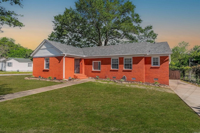 single story home with concrete driveway, brick siding, crawl space, and a front yard