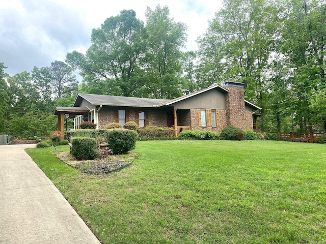 874 Stacy Spgs, Heber Springs, AR 72543 - view of front of home featuring a front yard, a chimney, and brick siding
