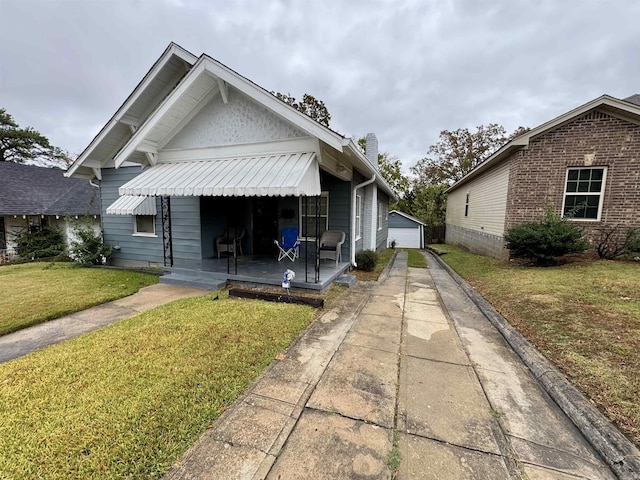 1519 S Oak St, Little Rock, AR 72204 - bungalow-style house with a garage, covered porch, a front yard, a chimney, and an outbuilding