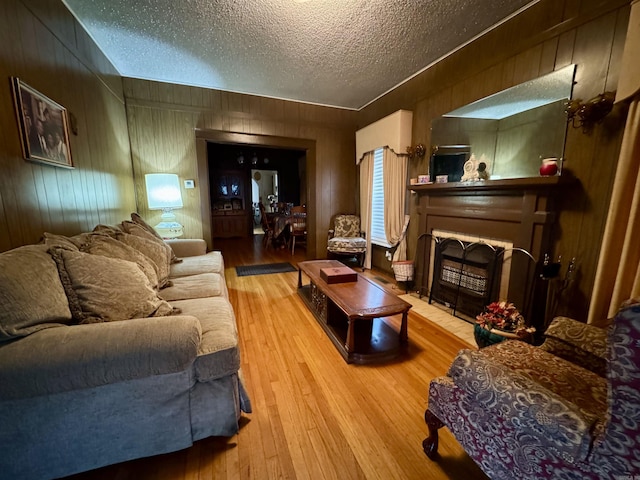 1519 S Oak St, Little Rock, AR 72204 - living room with a textured ceiling, wood walls, and wood finished floors