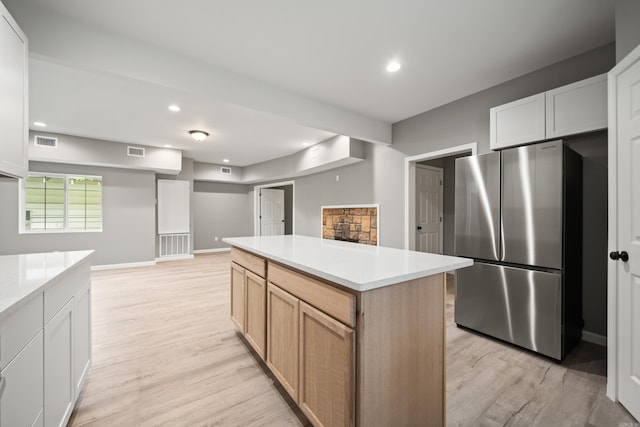 609 S St, Hot Springs, AR 71913 - kitchen featuring freestanding refrigerator, light countertops, visible vents, and light wood-type flooring