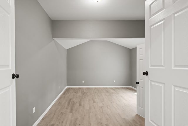609 S St, Hot Springs, AR 71913 - bonus room featuring baseboards, vaulted ceiling, and light wood-style flooring