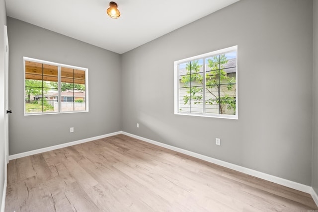 609 S St, Hot Springs, AR 71913 - empty room featuring baseboards, wood finished floors, and a wealth of natural light
